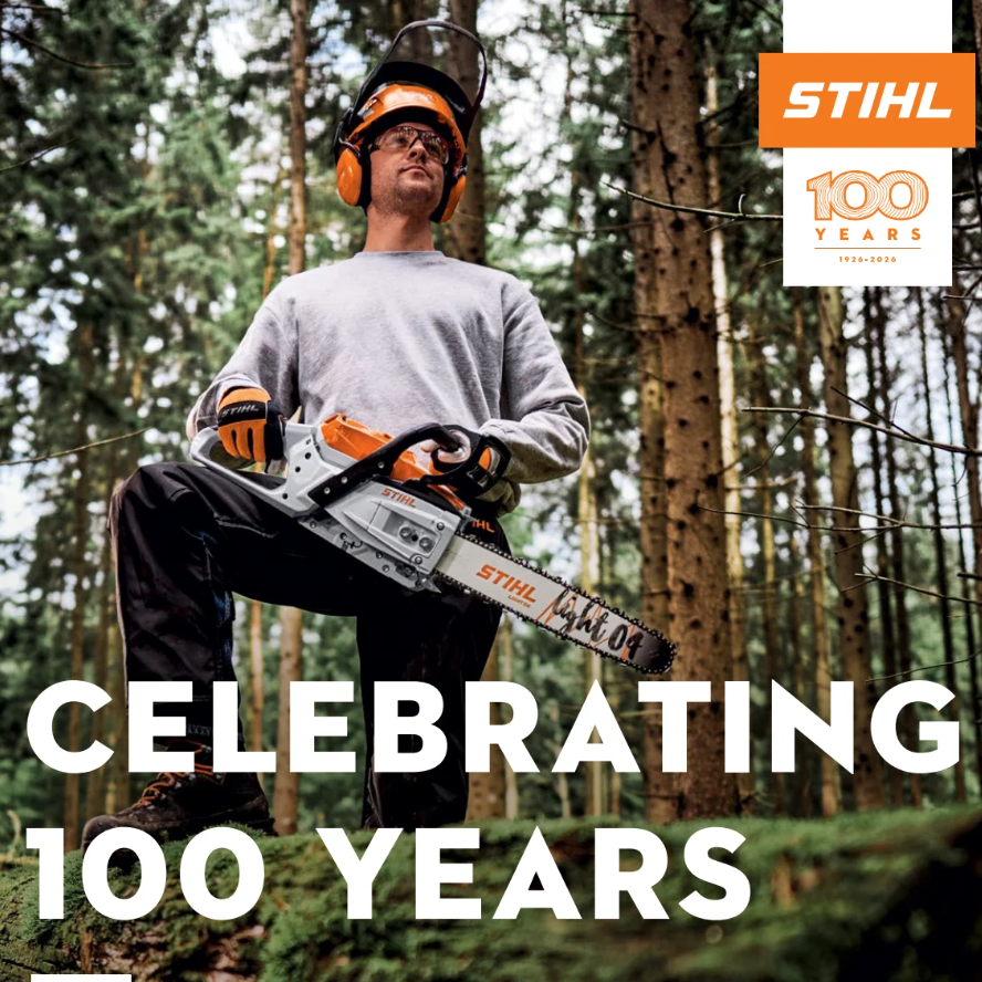 Person holding a chainsaw in a forest with STIHL branding and 'Celebrating 100 Years' text.
